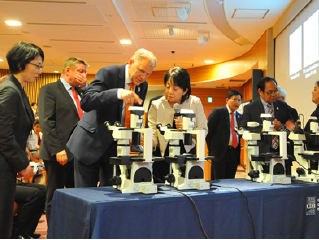 Participants looking at cells under a microscope at the RIKEN Center for Developmental Biology
