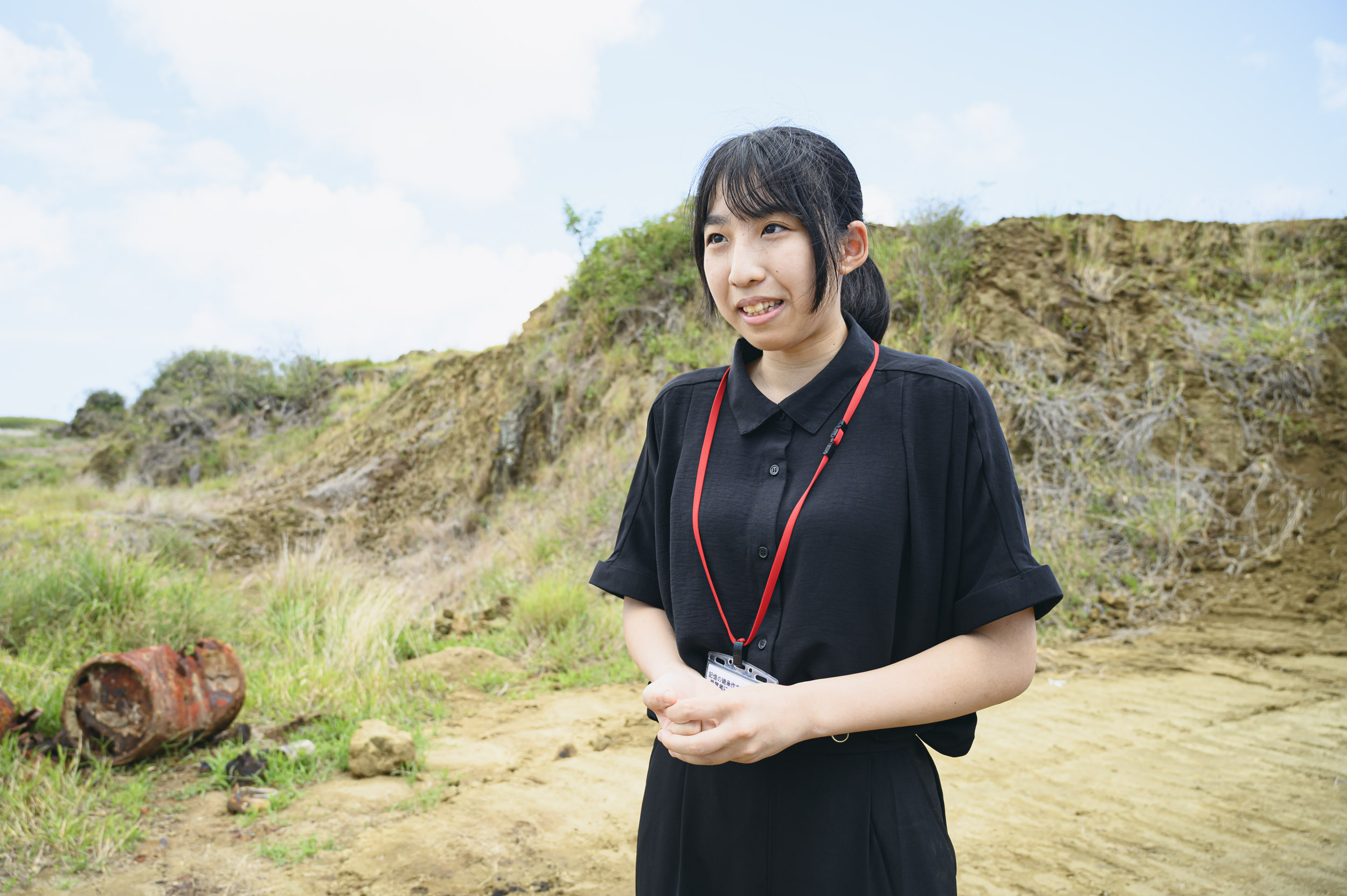 遺骨調査現場を背に語る植山さん